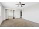 Bright bedroom with carpeted floors, ceiling fan, closet with sliding mirror doors, and plenty of room at 1411 W Mendoza Ave, Mesa, AZ 85202