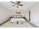 Bright bedroom with a ceiling fan, a bed, and an area rug on top of carpet, creating a cozy retreat at 1411 W Mendoza Ave, Mesa, AZ 85202