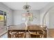 Bright dining room with hardwood floors, wood table, stylish decor, and a view to the outdoor area at 1411 W Mendoza Ave, Mesa, AZ 85202