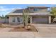 Inviting two-story home featuring a well-maintained yard and a spacious two-car garage at 1411 W Mendoza Ave, Mesa, AZ 85202