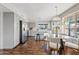 Open-concept kitchen and dining area with gray cabinets, stainless steel appliances, and backyard views at 1411 W Mendoza Ave, Mesa, AZ 85202