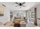 Comfortable living room area with a cozy couch, ceiling fan, view to the dining area, and an open floor plan at 1411 W Mendoza Ave, Mesa, AZ 85202