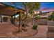 Covered outdoor patio with stone pavers, a water feature, and a view of the pool at 1411 W Mendoza Ave, Mesa, AZ 85202