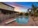 Enjoy the serene backyard featuring a private pool, diving board and mature landscaping at 1411 W Mendoza Ave, Mesa, AZ 85202