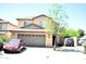 Charming two-story home with a well-maintained front yard and a spacious two-car garage at 1417 E Rosebud Dr, San Tan Valley, AZ 85143