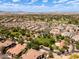 Wide aerial view showing a sprawling residential community with green spaces, golf courses and desert landscape at 14250 W Wigwam Blvd # 121, Litchfield Park, AZ 85340