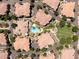 Overhead view of community featuring a pool, green spaces, and well-maintained residences with Spanish tile roofs at 14250 W Wigwam Blvd # 121, Litchfield Park, AZ 85340