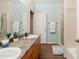 Bright bathroom featuring dual sinks, tile floors, and granite countertops at 14250 W Wigwam Blvd # 121, Litchfield Park, AZ 85340