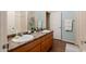 Bright bathroom featuring dual sinks, tile floors, and granite countertops at 14250 W Wigwam Blvd # 121, Litchfield Park, AZ 85340
