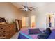 Spacious bedroom features neutral tones, ceiling fan, and a walk-in closet at 14250 W Wigwam Blvd # 121, Litchfield Park, AZ 85340