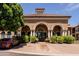 Welcoming clubhouse entrance with architectural details and lush landscaping at 14250 W Wigwam Blvd # 121, Litchfield Park, AZ 85340