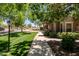 Manicured community with mature shade trees, green grass and sidewalks at 14250 W Wigwam Blvd # 121, Litchfield Park, AZ 85340