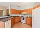 Well-lit kitchen boasts sleek countertops, white appliances, and ample cabinet space for storage at 14250 W Wigwam Blvd # 121, Litchfield Park, AZ 85340