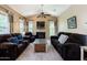 Comfortable living room with dark furniture, a fireplace and lots of natural light at 14250 W Wigwam Blvd # 121, Litchfield Park, AZ 85340