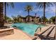 Sparkling community pool surrounded by palm trees and comfortable lounge chairs at 14250 W Wigwam Blvd # 121, Litchfield Park, AZ 85340