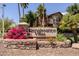 Elegant community signage with lush floral landscaping at 14250 W Wigwam Blvd # 121, Litchfield Park, AZ 85340