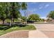 Picturesque street view with mature trees and well-maintained landscaping at 14250 W Wigwam Blvd # 121, Litchfield Park, AZ 85340