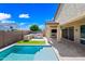 Beautiful backyard with pool, covered patio, outdoor kitchen and lush green artificial turf at 14413 W Eugene Ter, Surprise, AZ 85379