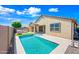 A luxurious backyard with a swimming pool, outdoor kitchen, patio and privacy fencing at 14413 W Eugene Ter, Surprise, AZ 85379
