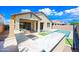 An inviting backyard featuring an outdoor kitchen, pool and well-maintained landscaping at 14413 W Eugene Ter, Surprise, AZ 85379