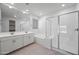 Bright bathroom featuring double sinks, soaking tub, walk in shower and large mirror at 14413 W Eugene Ter, Surprise, AZ 85379