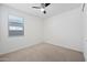 Bedroom with carpet, ceiling fan, and a bright window at 14413 W Eugene Ter, Surprise, AZ 85379