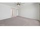 Bright bedroom featuring a ceiling fan and a light-colored carpet at 14413 W Eugene Ter, Surprise, AZ 85379
