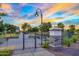 Inviting community entrance with decorative signage, landscaping, and wrought-iron gates at 14413 W Eugene Ter, Surprise, AZ 85379