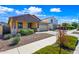 Beautiful home with a well-manicured lawn, attractive landscaping, and a two-car garage with a long driveway at 14413 W Eugene Ter, Surprise, AZ 85379