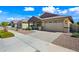 Charming single-story home showcasing a two-car garage, well-maintained landscaping, and a welcoming front porch at 14413 W Eugene Ter, Surprise, AZ 85379