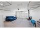 Spacious garage with overhead storage racks and roll-up garage door at 14413 W Eugene Ter, Surprise, AZ 85379