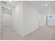 Bright hallway featuring tile floors and access to the front door and other rooms at 14413 W Eugene Ter, Surprise, AZ 85379