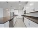 Chic kitchen with white cabinets, stainless steel appliances, and a sleek countertop space at 14413 W Eugene Ter, Surprise, AZ 85379