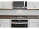 Close-up of the kitchen features stainless steel oven and microwave appliances at 14413 W Eugene Ter, Surprise, AZ 85379
