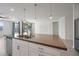 Kitchen island sink, modern pendant lights, stainless appliances, and outdoor views at 14413 W Eugene Ter, Surprise, AZ 85379