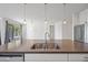 Kitchen island featuring stainless steel sink and modern pendant lights at 14413 W Eugene Ter, Surprise, AZ 85379