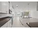 Bright and open kitchen with white cabinetry, stainless appliances, and a spacious island for dining at 14413 W Eugene Ter, Surprise, AZ 85379