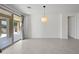 Bright, airy living room featuring neutral color palette, tile flooring and sliding glass door to backyard patio at 14413 W Eugene Ter, Surprise, AZ 85379