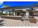 Outdoor kitchen area with bar seating and covered pergola, perfect for entertaining at 14413 W Eugene Ter, Surprise, AZ 85379