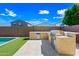 Backyard features an outdoor kitchen, stainless steel grill, countertop space, and backyard pool area at 14413 W Eugene Ter, Surprise, AZ 85379