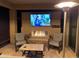 Cozy outdoor living space with a fireplace, TV, and comfortable seating, perfect for relaxing and entertaining at 14413 W Eugene Ter, Surprise, AZ 85379