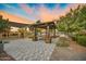 Beautiful park area with covered picnic tables, landscaping, and a playground at 14413 W Eugene Ter, Surprise, AZ 85379