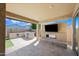 Spacious covered patio with outdoor kitchen, fireplace and TV, perfect for entertaining at 14413 W Eugene Ter, Surprise, AZ 85379
