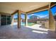 Spacious covered patio showcasing stone flooring, backyard pool and outdoor kitchen area at 14413 W Eugene Ter, Surprise, AZ 85379