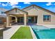 Entertainer's backyard features a covered patio with a fireplace, a built-in BBQ, and a pool with turf at 14413 W Eugene Ter, Surprise, AZ 85379