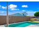 Backyard pool area features a waterfall feature, built in BBQ and well manicured, lush landscaping at 14413 W Eugene Ter, Surprise, AZ 85379