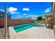 Backyard pool area with a built-in BBQ and well-manicured landscaping for relaxing and entertaining at 14413 W Eugene Ter, Surprise, AZ 85379