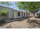 Backyard featuring large trees, rocks, and wood fence providing privacy at 1450 E Topeka Dr, Phoenix, AZ 85024