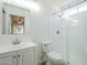 All-white bathroom with glass shower door, stylish fixtures, and modern vanity at 1450 E Topeka Dr, Phoenix, AZ 85024