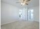 Bright bedroom with neutral carpet, ceiling fan, and white trim showcases a comfortable living space at 1450 E Topeka Dr, Phoenix, AZ 85024